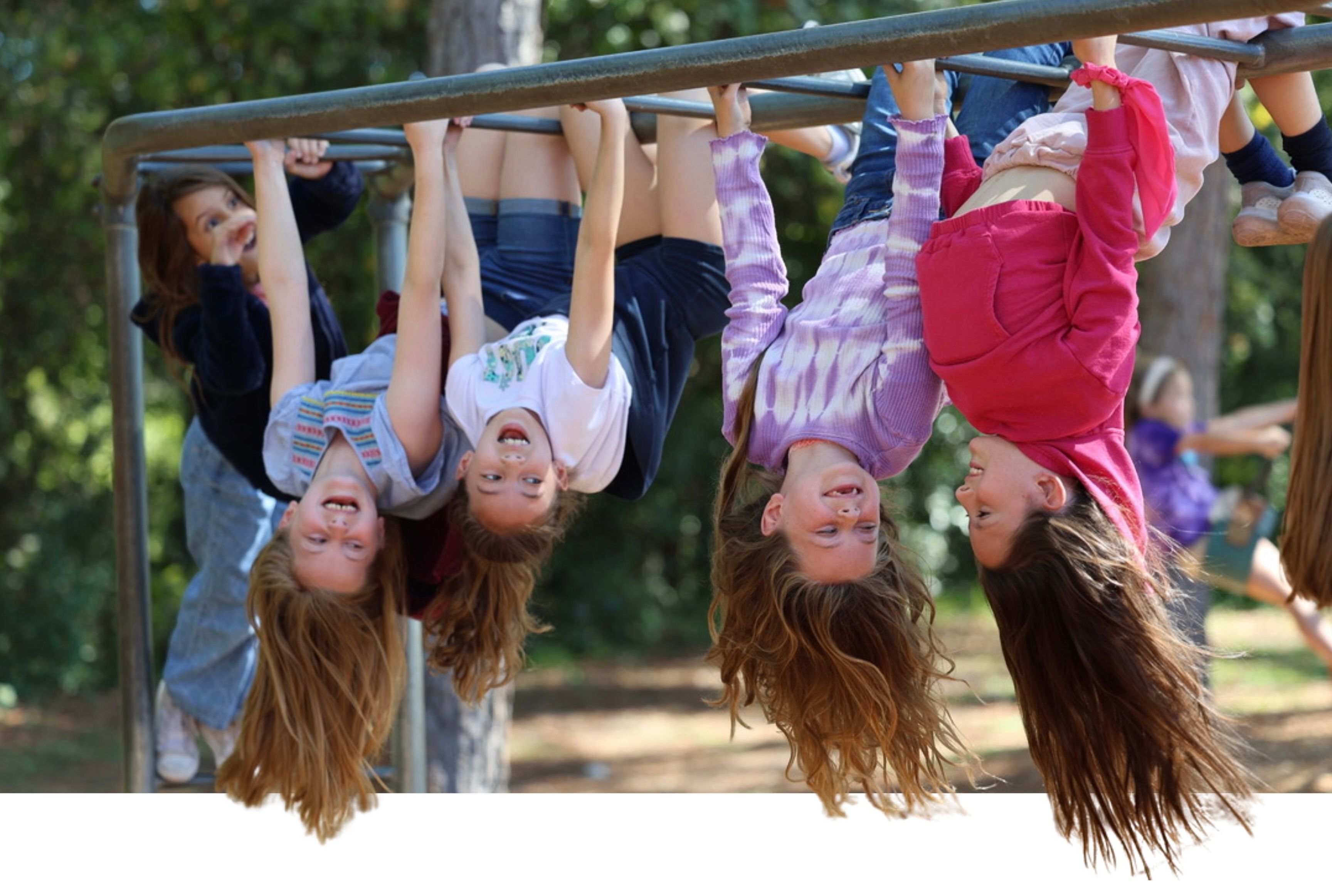 Elementary students playing on the monkey bars
